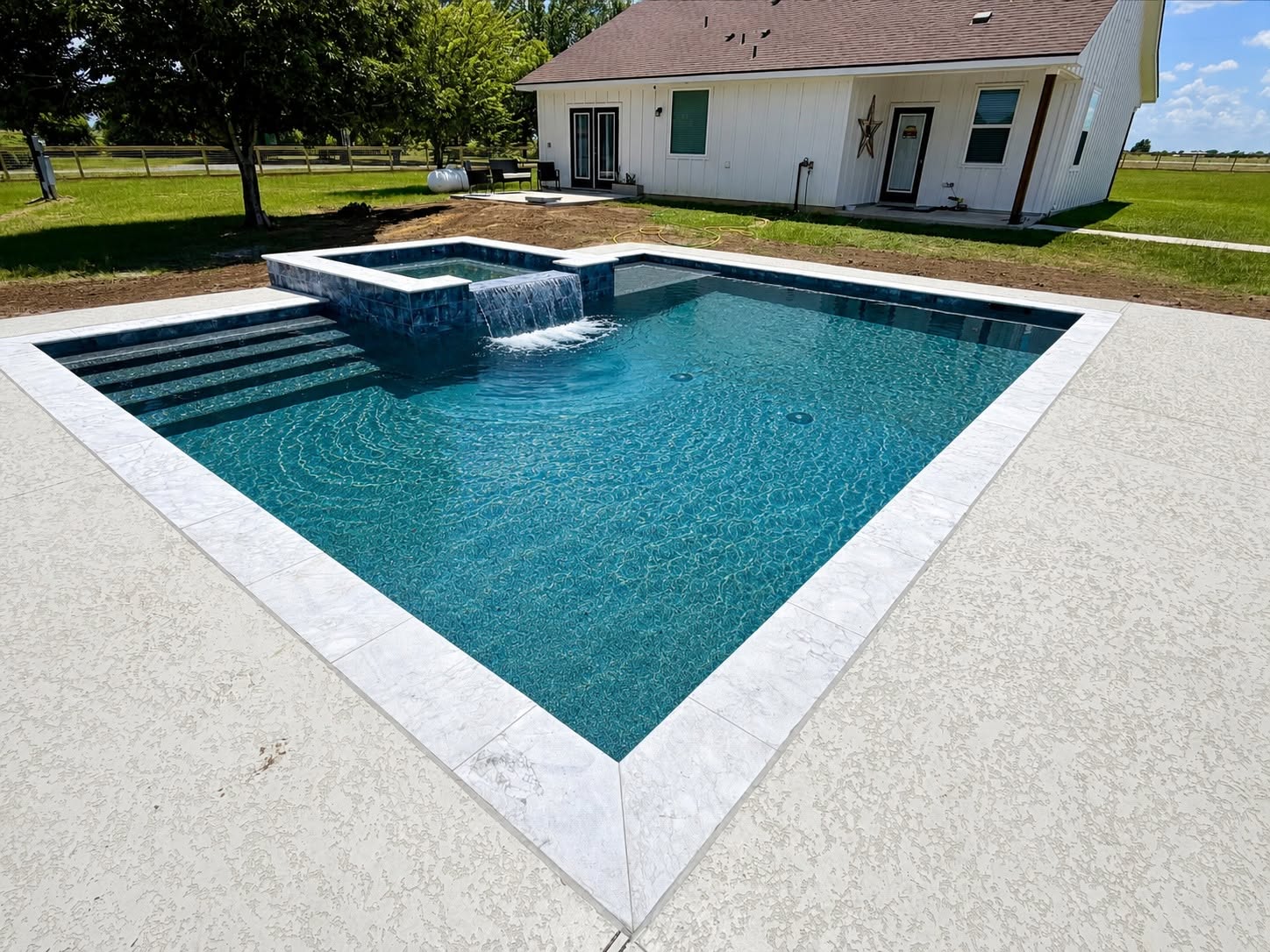 Geometric pool with raised spa and spillway