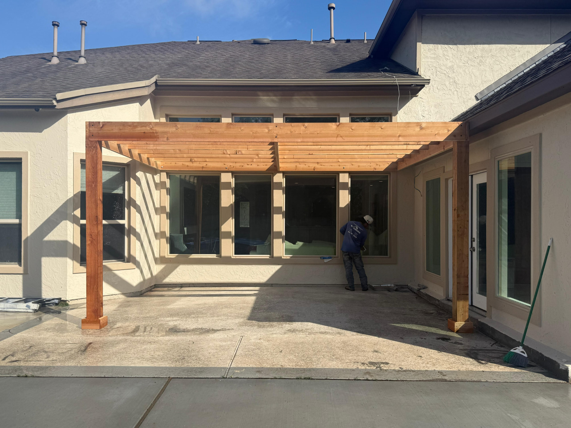 Cedar pergola over a concrete patio