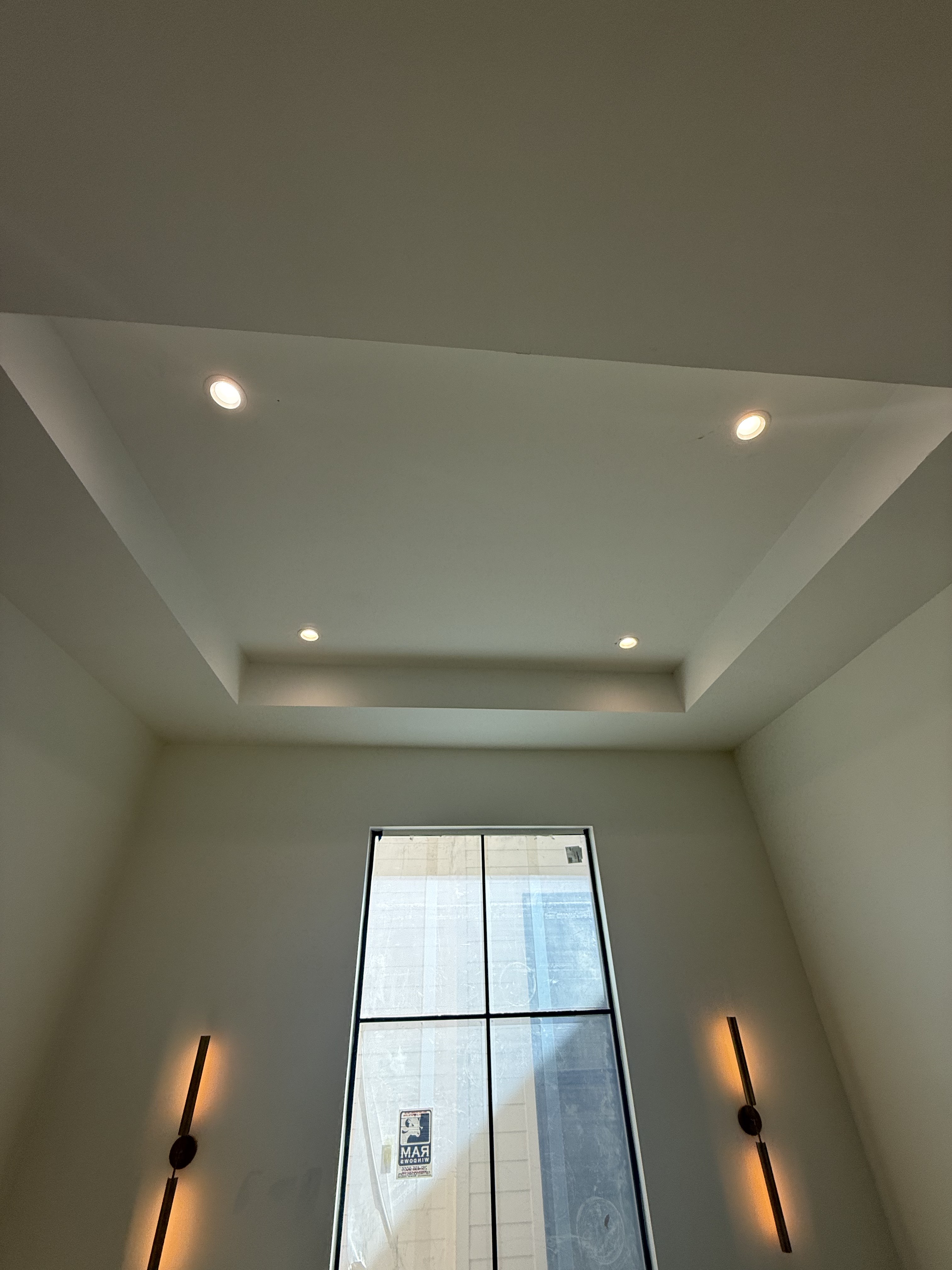 Tray ceiling with recessed lighting and sconces